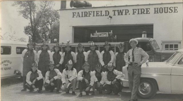 Old Fire House with firefighters in front